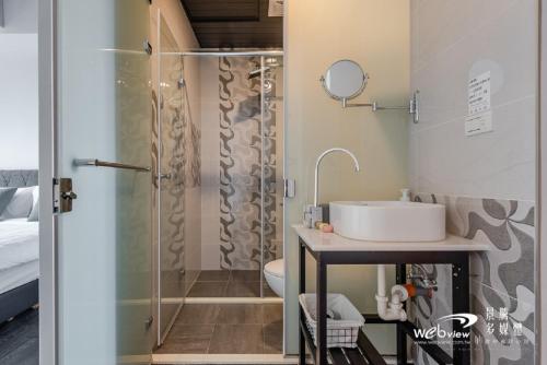 a bathroom with a sink and a shower at Wu Ting Stay in Hualien City