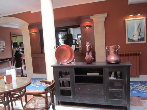 a room with a table and a bowl on a cabinet at Hotel Finca La Mansión in Llanes