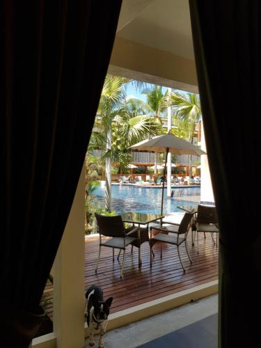 a view of a deck with a table and chairs and a pool at Ayara Villas - SHA Extra Plus in Khao Lak