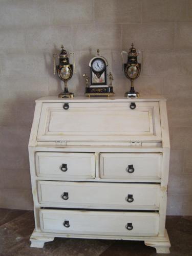 a dresser with two clocks on top of it at Hotel Finca La Mansión in Llanes