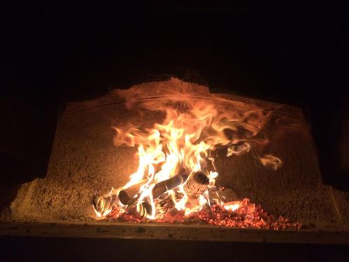a fire in a brick oven filled with fire at Villa Giuanne in Arenzano