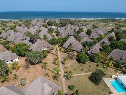 an aerial view of a resort with trees and houses at Karibuni Hotel & Villas in Mambrui