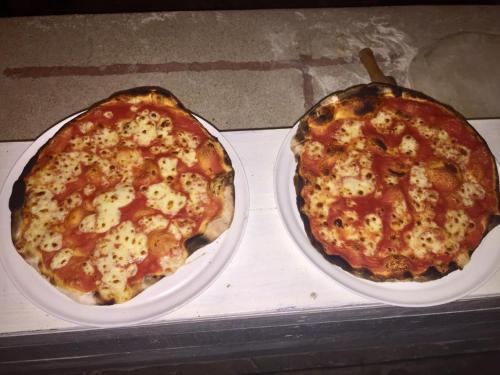 two pizzas sitting on top of a counter at Karibuni Hotel & Villas in Mambrui