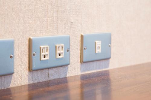 a row of light switches on a wall at Just Live Inn-Taipei Station in Taipei