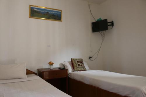 Ein Bett oder Betten in einem Zimmer der Unterkunft Gurkha Lodge