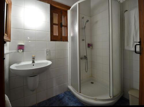 
a bathroom with a shower, sink, and toilet at Linos Inn in Kakopetria
