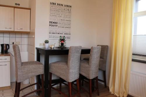 a kitchen with a table and four chairs at Schwiizeralp Hotel & Restaurant in Stemwede