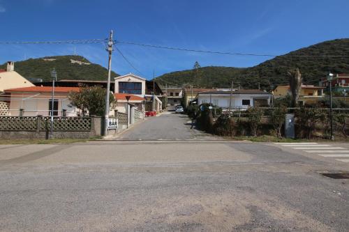 an empty street in a small town with houses at Appartamento Oleandro Piccolo Gutturu in Marina di Arbus