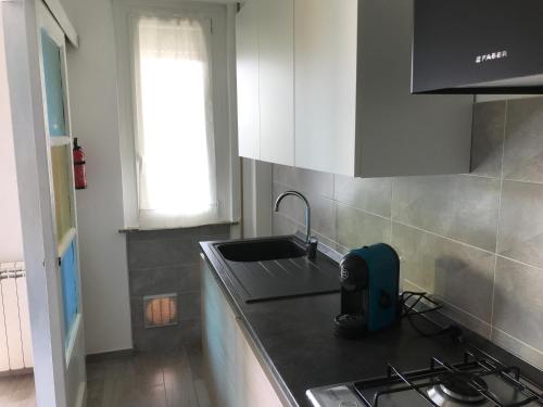 a kitchen with a sink and a stove top oven at LA CONCHIGLIA A MARINA in Marina di Carrara
