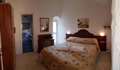 a bedroom with a bed with two shoes on it at Agriturismo Tholos in Roccamorice