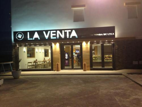 a store front of a restaurant at night at Hotel Venta del Pobre in Níjar