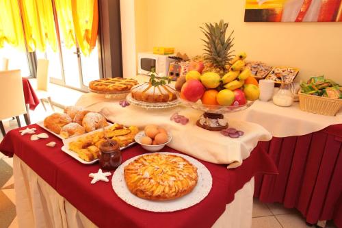 a table with many different types of food on it at Hotel Stefan Room & Breakfast in Gatteo a Mare