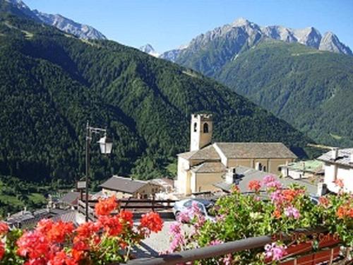a view of a town with mountains in the background at Albergo Eden in Ponte di Legno