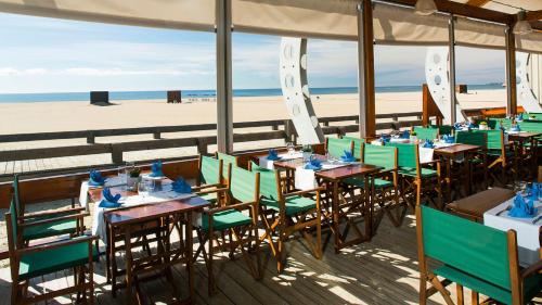 a restaurant on the beach with tables and chairs at Beach Apartment Vilamoura Villa Columbus in Vilamoura
