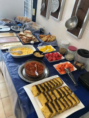 a table with many different types of food on it at Pousada Recanto do Arraial do Cabo in Arraial do Cabo