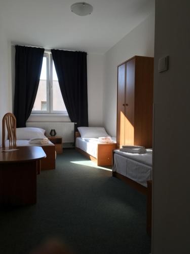 a hotel room with two beds and a window at Hotel Arko in Prague