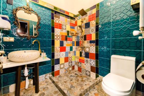 a bathroom with a sink and a toilet at Tiflis Inn Boutique Hotel in Tbilisi City