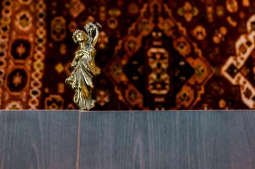 a gold trophy sitting on top of a shelf at Tiflis Inn Boutique Hotel in Tbilisi City