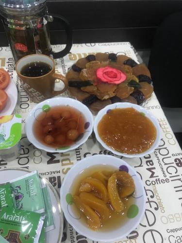 a table with bowls of food on a table at Hotel Victoria in Yerevan