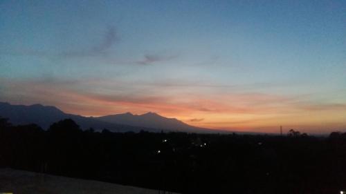 a sunset with a mountain in the background at Anyar in Mataram