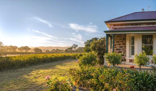 a house with a garden next to a field at Barossa Shiraz Estate in Lyndoch
