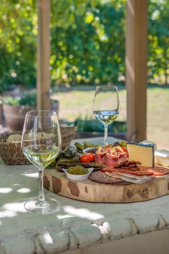 a table with two glasses of wine and a plate of food at Barossa Shiraz Estate in Lyndoch