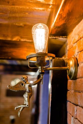 a light on a wall with a bird on it at Tiflis Inn Boutique Hotel in Tbilisi City