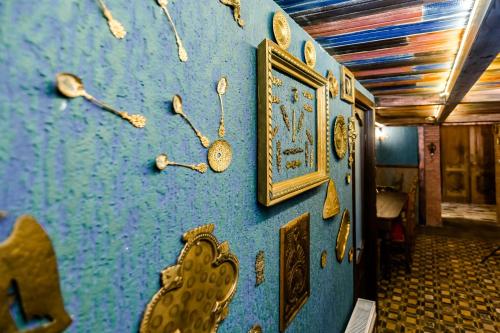 a blue wall with clocks on it at Tiflis Inn Boutique Hotel in Tbilisi City
