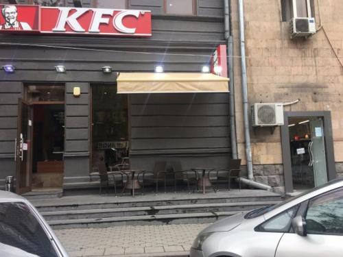a restaurant with tables and chairs outside of a building at Hotel Victoria in Yerevan