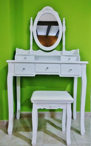a white dressing table with a mirror and a stool at Posada Del Camino Real in Torrelaguna