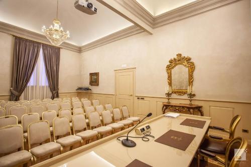 a conference room with chairs and a table and a mirror at Hotel Cavour in Bologna