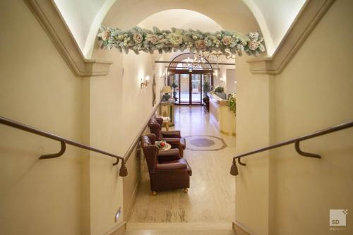 a hallway with couches and flowers on the ceiling at Hotel Cavour in Bologna