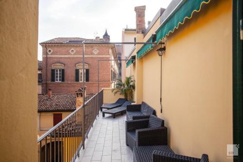 a balcony with black chairs on a building at Hotel Cavour in Bologna