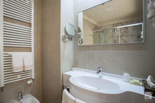 a bathroom with a sink and a mirror at Hotel Cavour in Bologna