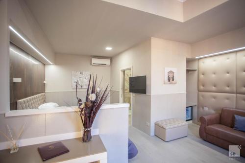 a living room with a couch and a table at Hotel Cavour in Bologna