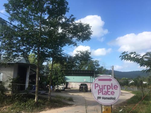 a purple plate sign in front of a house at Purple Place Homestay Phu Quoc in Phu Quoc