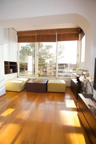 a living room with wooden floors and a large window at Argola Kraljevica apartment in Kraljevica