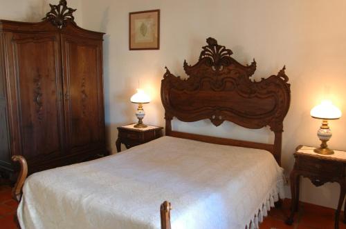 a bedroom with a bed and two night stands with lamps at Quinta do Cabeçote in Cabeço de Vide