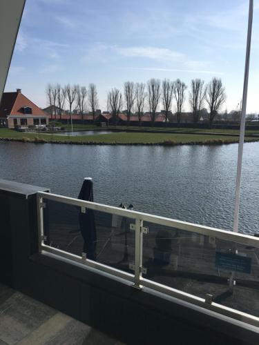 a person standing on a boat in the water at Appartementen De Helling 44 in Heeg