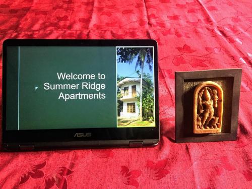 a tablet computer with a picture of a summer ridge apartments at Summer Ridge - Homestay in Ratnapura