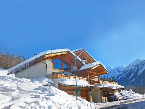 a building covered in snow with a mountain at Modern chalet just 350 m from the ski lifts in Peisey-Nancroix
