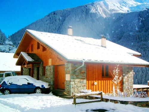 a house with a car parked in the snow at Luxurious Chalet in Champagny en Vanoise near Ski Area in Champagny-en-Vanoise