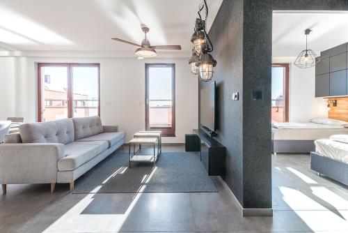 a living room with a couch and a bed at CITYSTAY Chmielna Apartments in Gdańsk