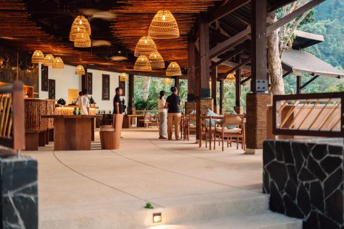 un restaurante con gente de pie en un edificio en Awei Pila (Mergui Archipelago), en Kyun Pila Island.