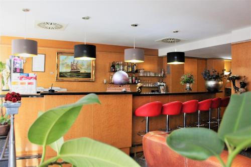 a kitchen with a large counter top and a large window at Hotel Batavia in Düsseldorf