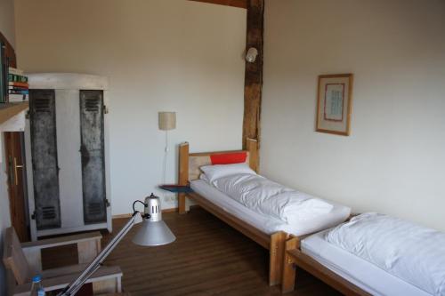 a room with two beds and a lamp in it at Naturata Hotel in Überlingen