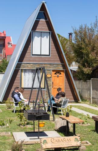 a group of people sitting in front of a house at Pyramidal Park Valdivia in Valdivia