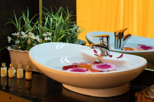 
a sink with a bowl of water and a bowl of soap at Fun Retreat Resort, Hotel and Ayurveda Spa in Arusha

