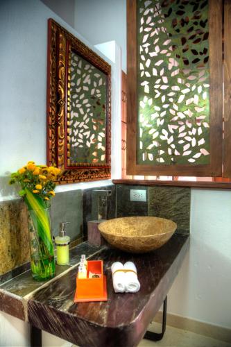 a bathroom with a sink and a bowl on a counter at Casa de Leda, a Kali Hotel in Santa Marta