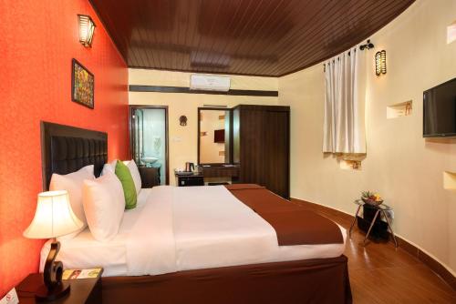 a bedroom with a large bed in a room at Fun Retreat Resort, Hotel and Ayurveda Spa in Arusha